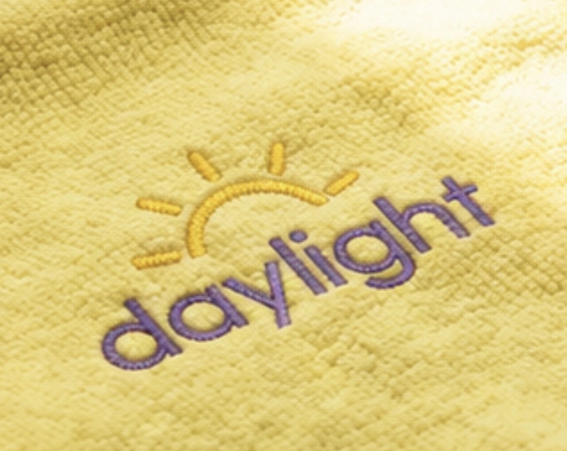 Close view of a yellow Daylight towel on a sunlit kitchen counter